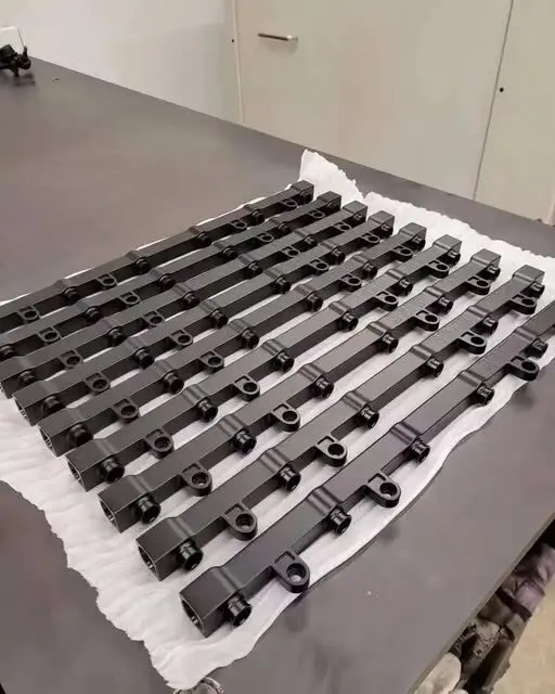 Batch of long black machined components
